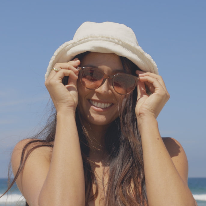 woman trying on makani sunglasses