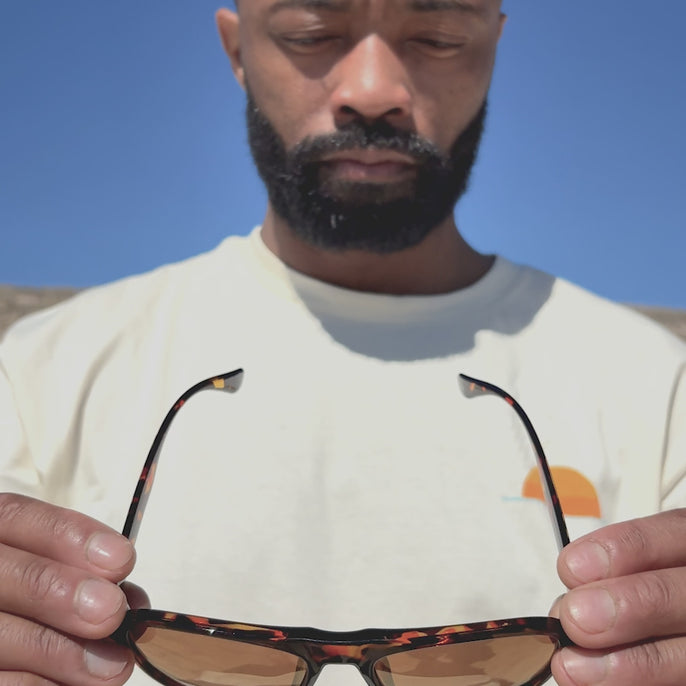 man trying on shoreline sunski sunglasses