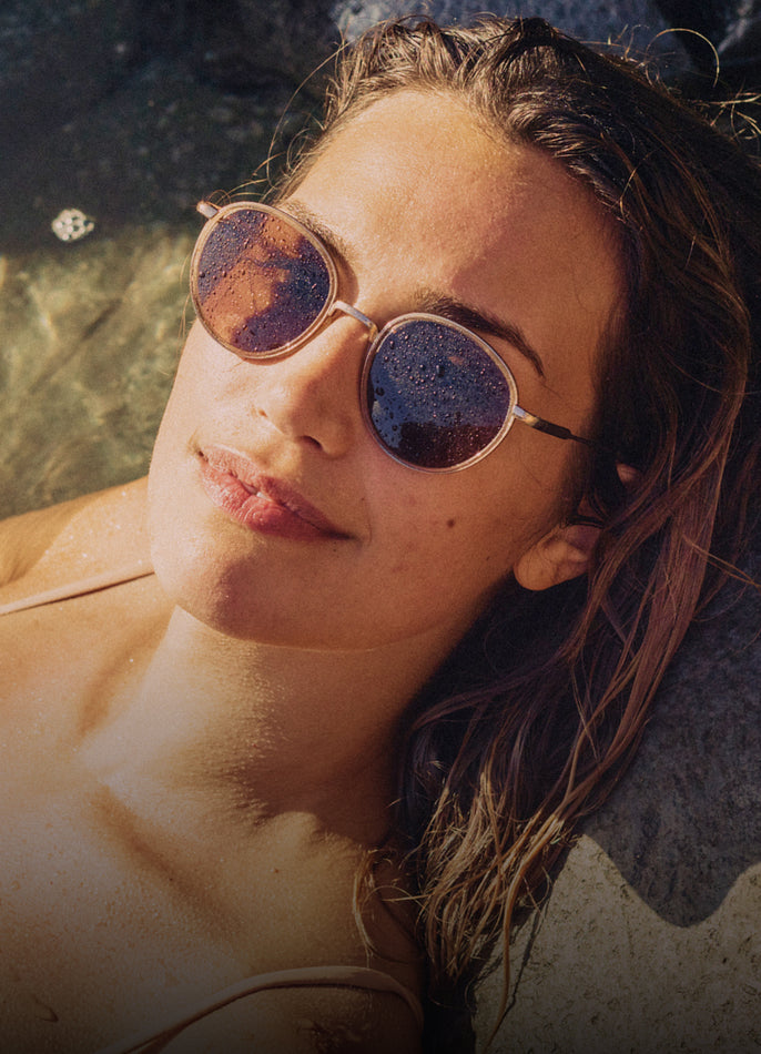 Woman wearing sunglasses with a blurred natural background