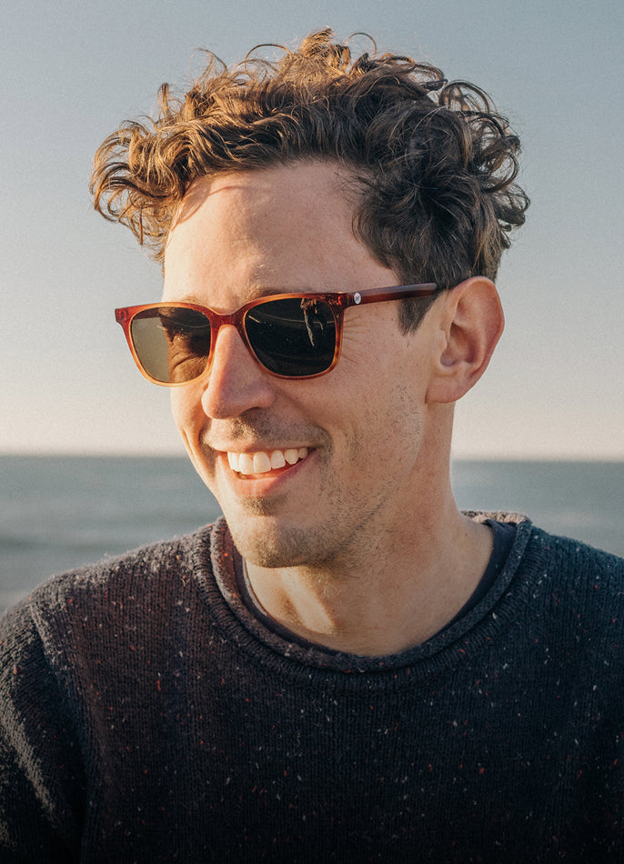 Man wearing sunglasses with a blurred background