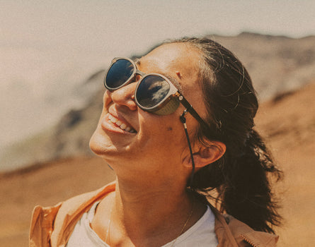 woman looking up at the sun wearing sunski tera sunglasses