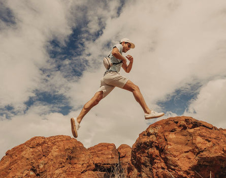 guy jumping on rocks wearing sunski sling