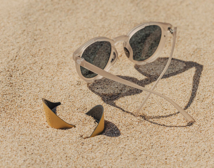STORY sunski tera sun shields laying next to sunski tera sunglasses