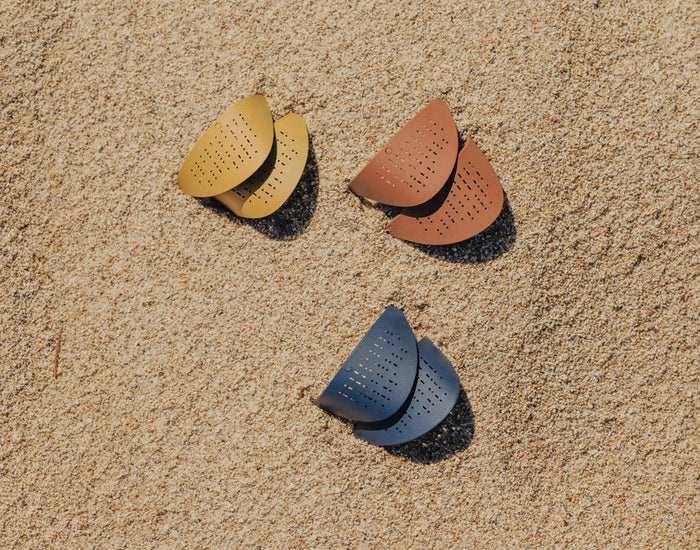 STORY sunski tera sun shields laying the sand
